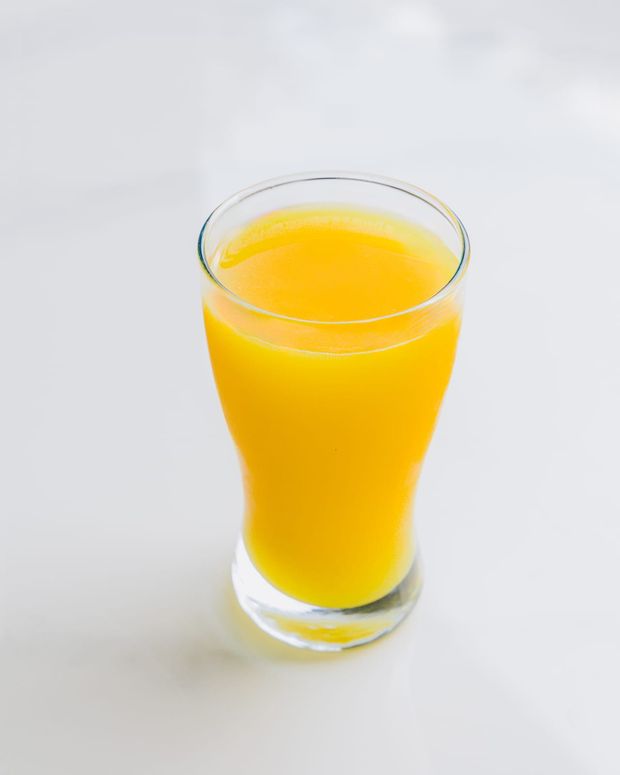 A tall glass of freshly pressed mango juice