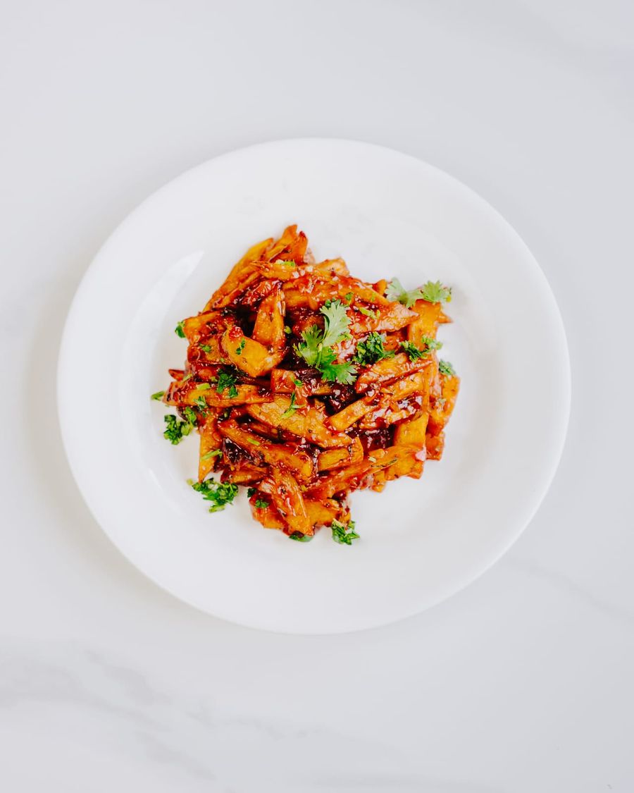 Thick-cut chips tossed in a glossy red masala sauce and scattered with fresh coriander